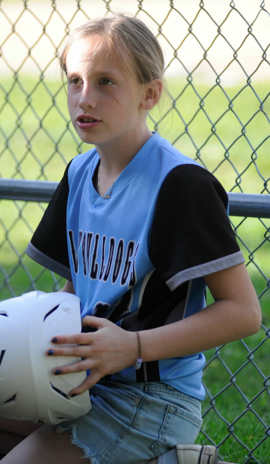 Allie Hellerer, #42, is the fifth-grade, 10-year-old co-manager for Sullivan West’s varsity softball squad. A Little Leaguer, she pitches and plays first base, and is pictured arranging bats and helmets between innings...